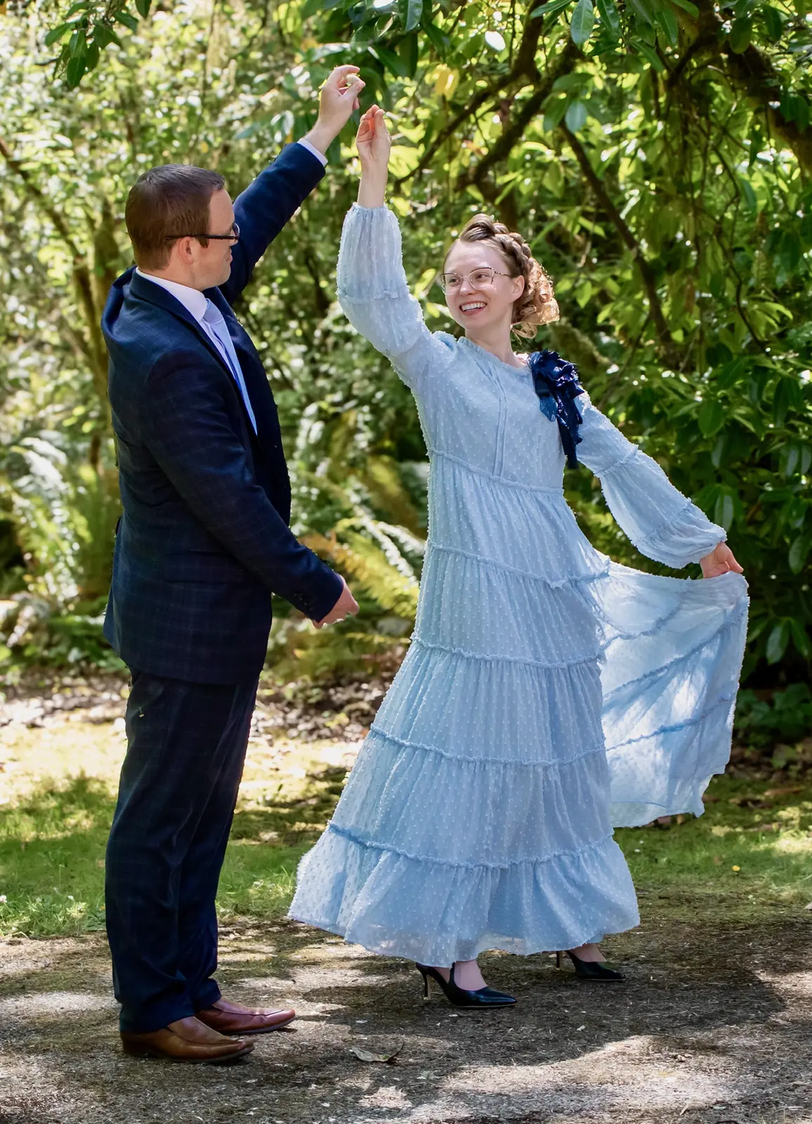 Caleb twirling Alyssa as they dance outdoors